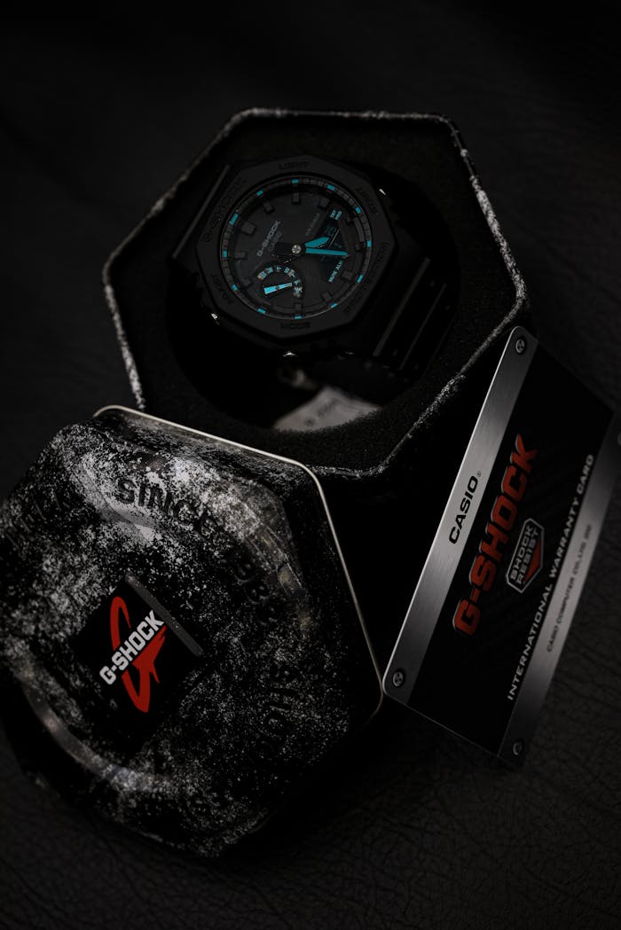 Casio G-Shock watch in a stylish display box on a textured leather surface.